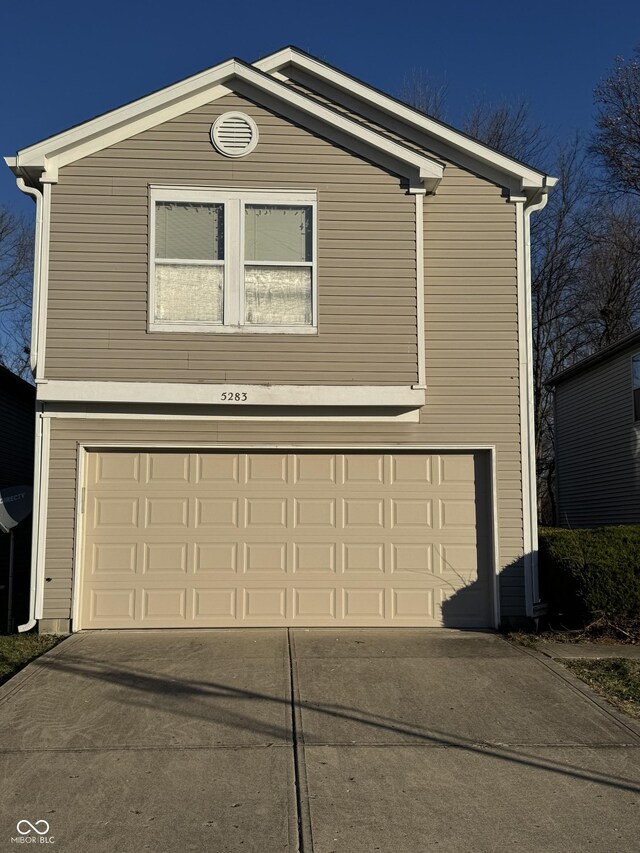 5283 Tufton Dr, Indianapolis, IN 46254 - traditional home with an attached garage and concrete driveway