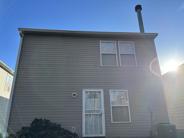 rear view of property featuring central AC unit