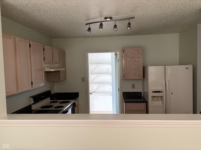 kitchen with a textured ceiling, white appliances, rail lighting, and light brown cabinets