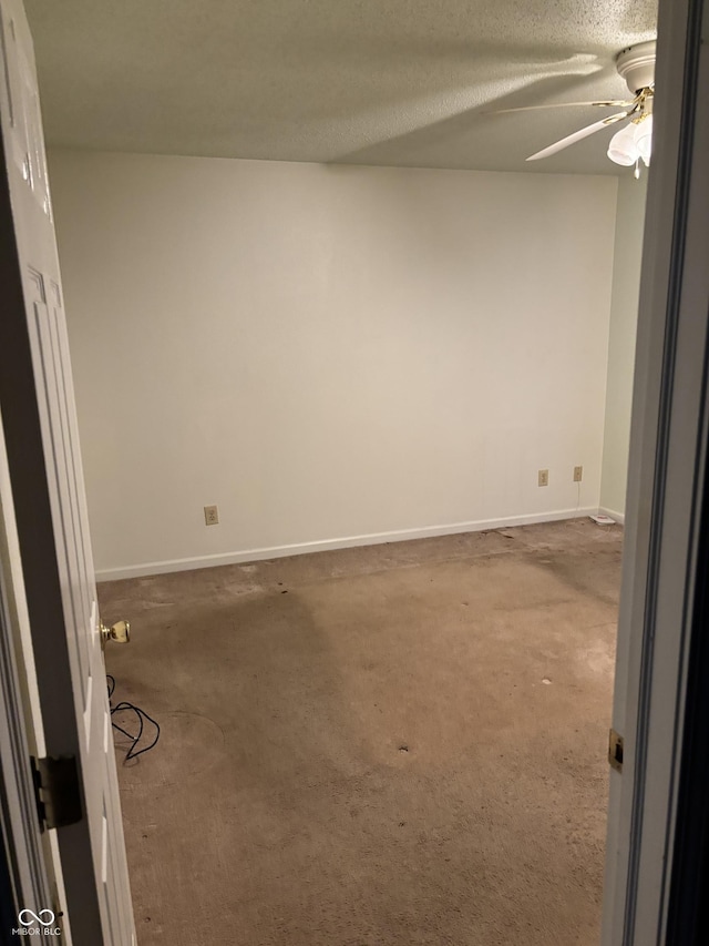 empty room featuring a textured ceiling and carpet floors