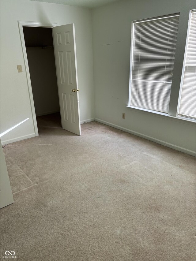 5283 Tufton Dr, Indianapolis, IN 46254 - unfurnished bedroom with carpet and baseboards