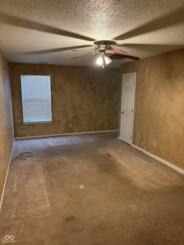 unfurnished room featuring ceiling fan and a textured ceiling