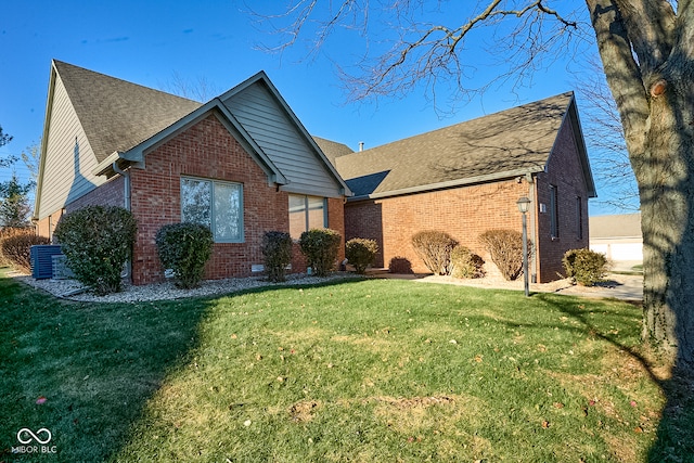 view of front of property with a front lawn and central air condition unit