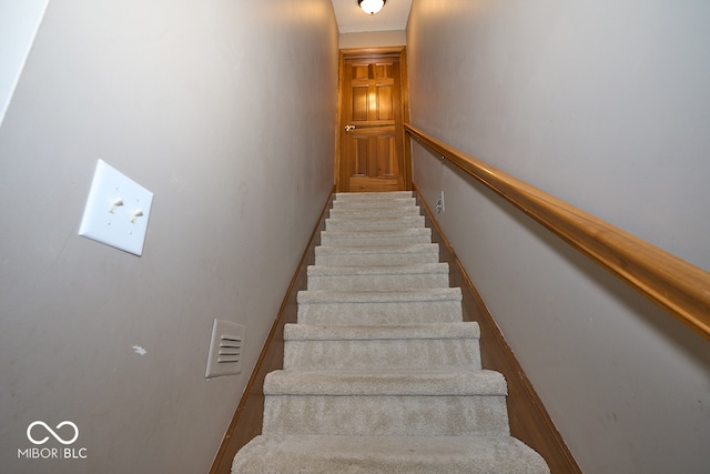 stairs featuring wood-type flooring