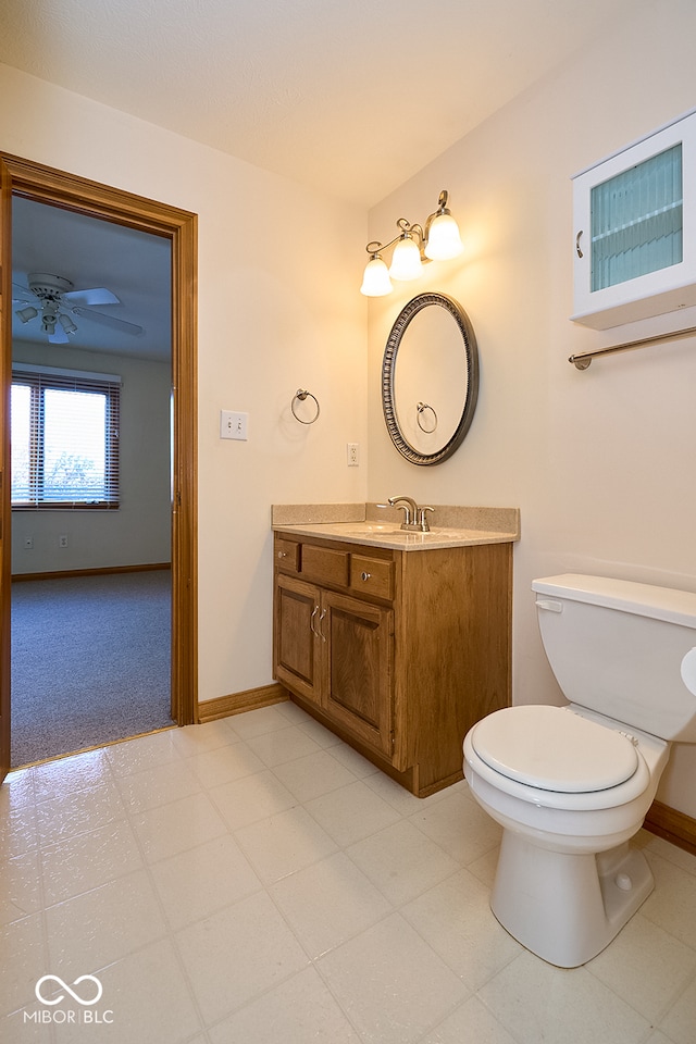 bathroom with vanity, toilet, and ceiling fan