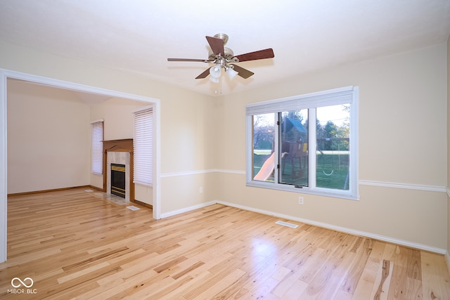 unfurnished living room featuring ceiling fan and light wood-type flooring