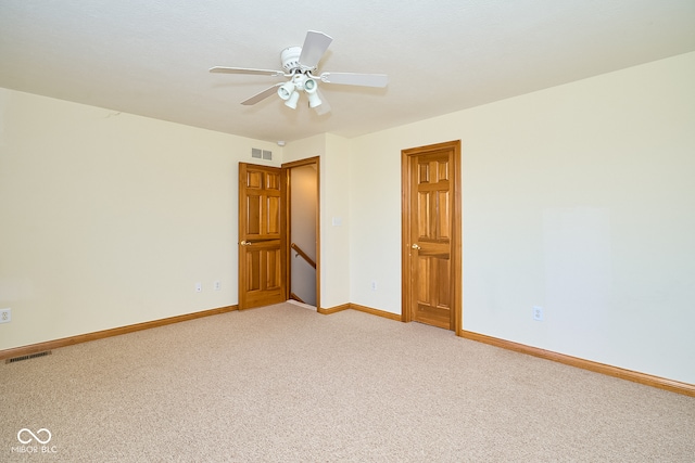 carpeted spare room featuring ceiling fan