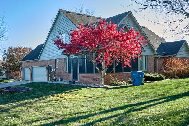 view of property exterior featuring a lawn, a sunroom, and a garage