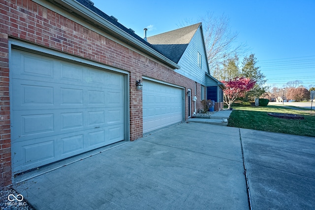 view of property exterior with a garage and a yard