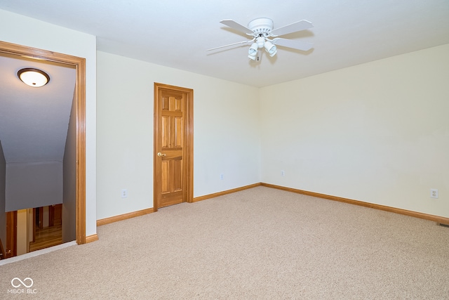 carpeted spare room featuring ceiling fan