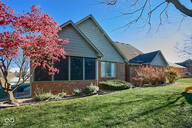 view of side of property featuring a yard