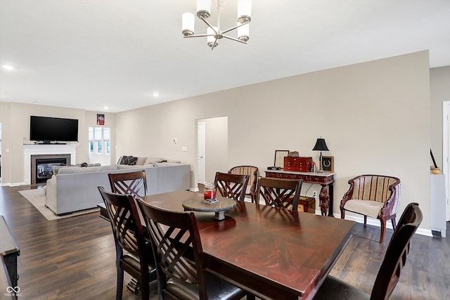 dining area featuring a notable chandelier and dark hardwood / wood-style flooring