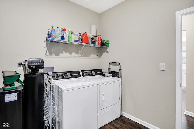 laundry room with dark hardwood / wood-style flooring and independent washer and dryer