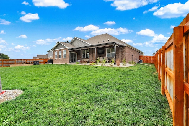 rear view of property with a lawn