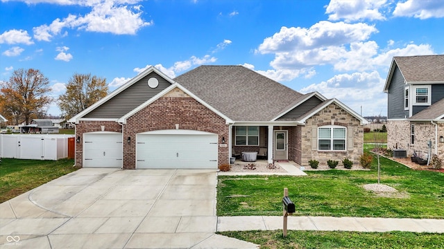 craftsman-style home featuring central air condition unit, a front lawn, and a garage