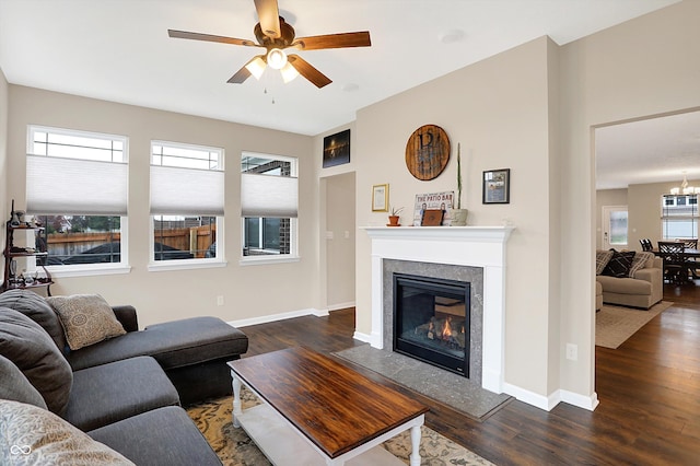 living room featuring ceiling fan, dark hardwood / wood-style flooring, and a wealth of natural light