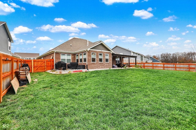 rear view of house with a patio and a lawn