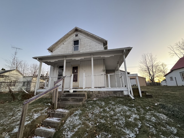 view of front of house with a porch and a lawn