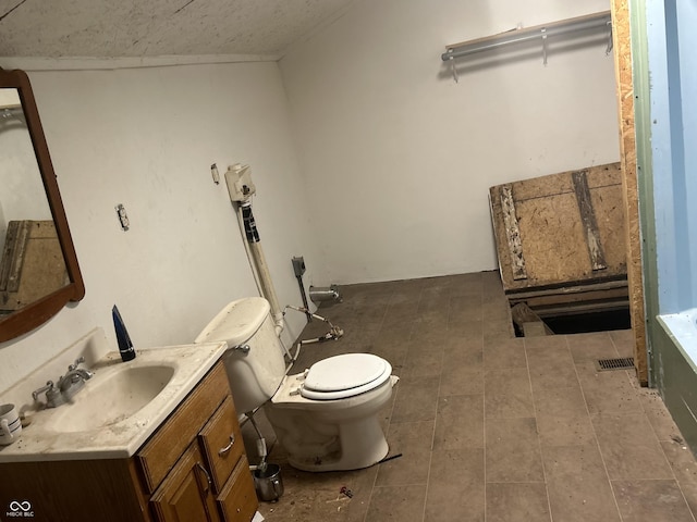 bathroom featuring vanity, toilet, and a bathtub