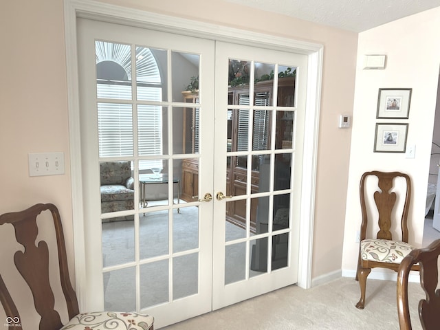 doorway featuring french doors, carpet floors, and a textured ceiling