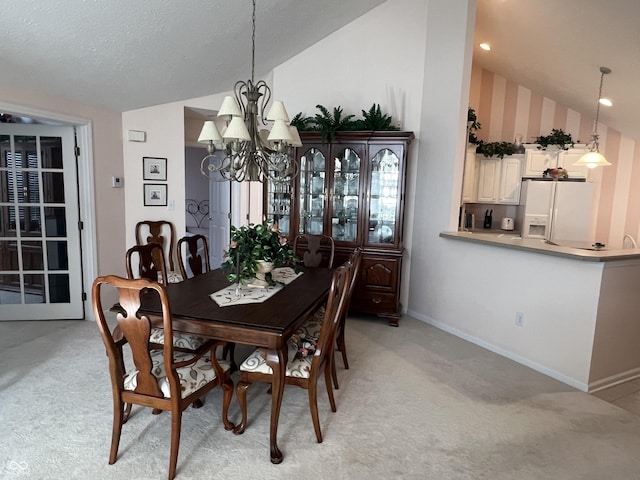 carpeted dining room featuring a textured ceiling, lofted ceiling, and a notable chandelier