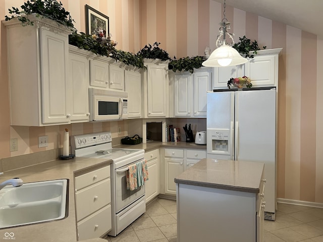 kitchen with white appliances, sink, pendant lighting, a kitchen island, and light tile patterned flooring