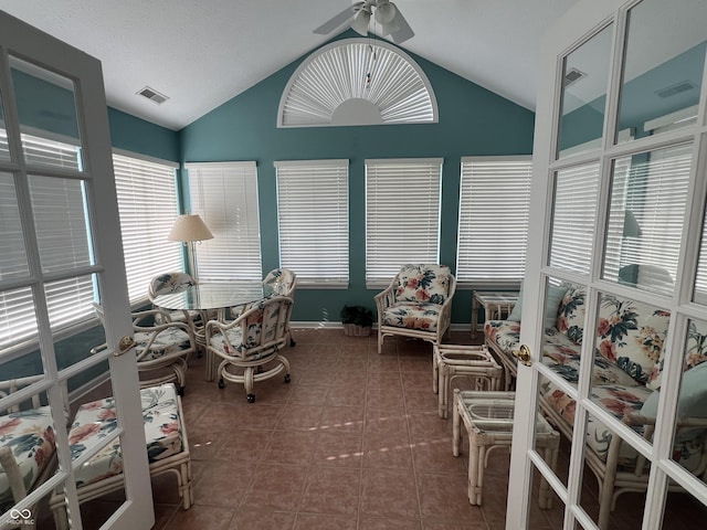 sunroom with ceiling fan and lofted ceiling