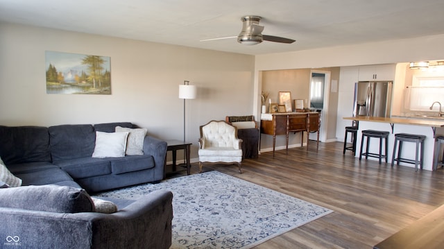 living room with a wealth of natural light, ceiling fan, dark hardwood / wood-style flooring, and sink