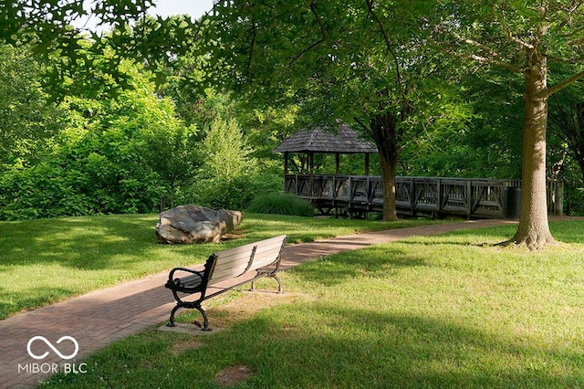 surrounding community with a lawn and a gazebo