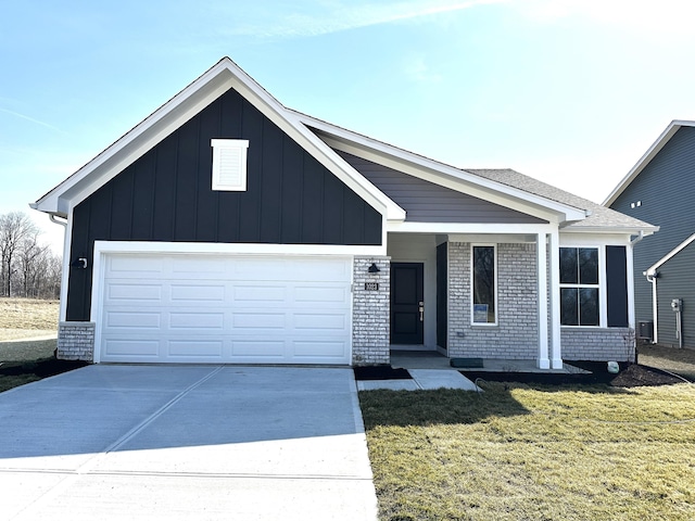 view of front facade featuring brick siding, board and batten siding, a front yard, a garage, and driveway