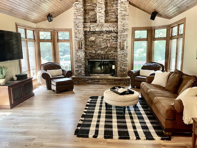 living room with a stone fireplace, high vaulted ceiling, wood ceiling, and wood finished floors