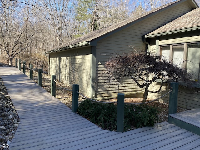 view of side of home featuring a shingled roof