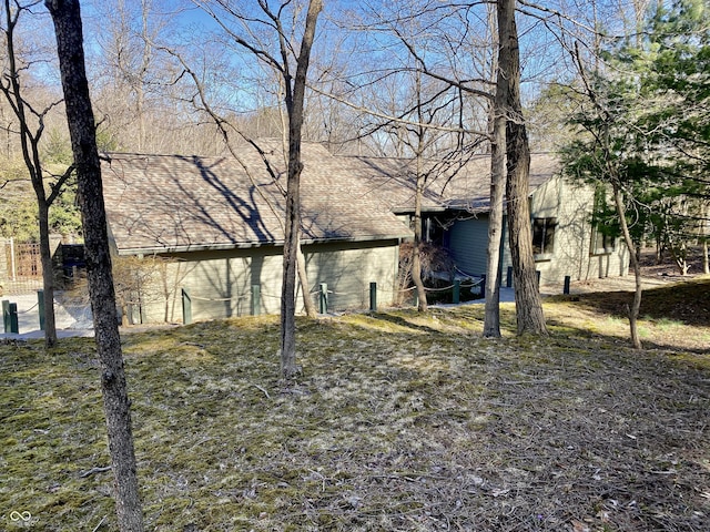 exterior space with roof with shingles