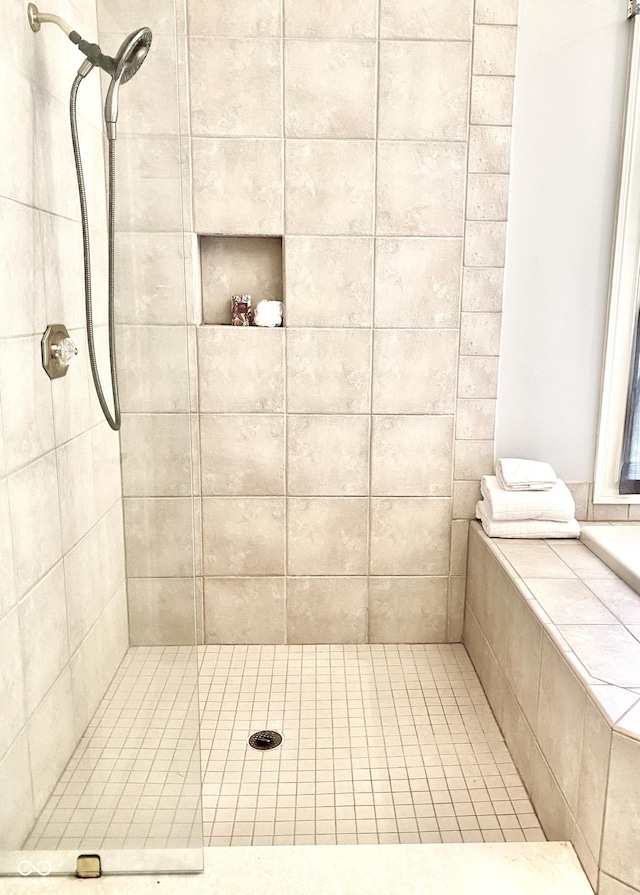 full bath with a tile shower