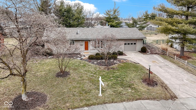 ranch-style house with roof with shingles, an attached garage, fence, driveway, and a front lawn