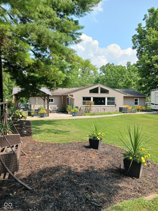 view of yard with central AC and a patio