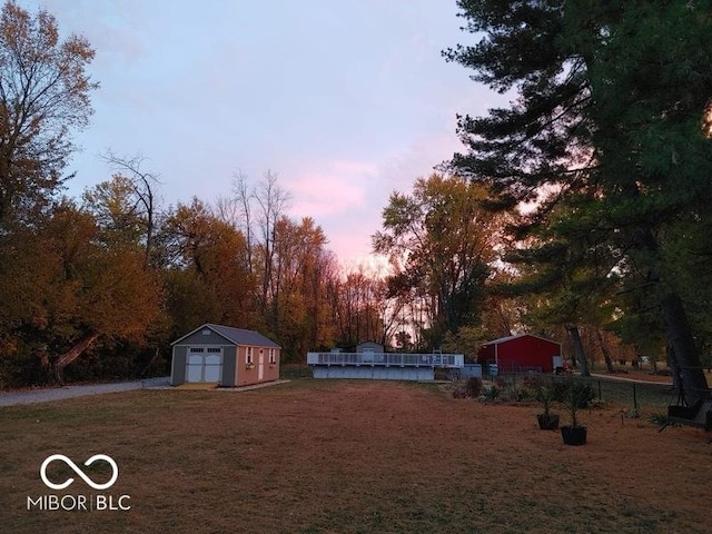 yard at dusk with a storage unit