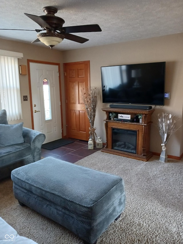 tiled living room featuring ceiling fan and a textured ceiling