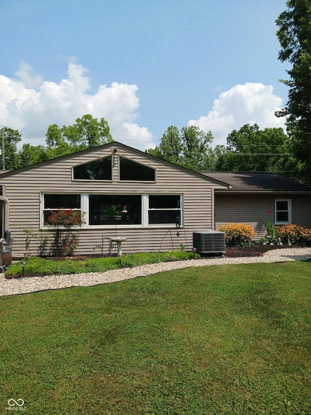 view of front facade with central AC and a front lawn