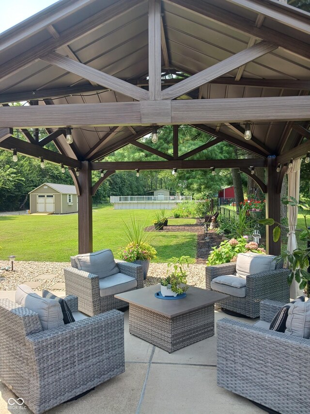 view of patio / terrace featuring a gazebo, a storage shed, and an outdoor living space