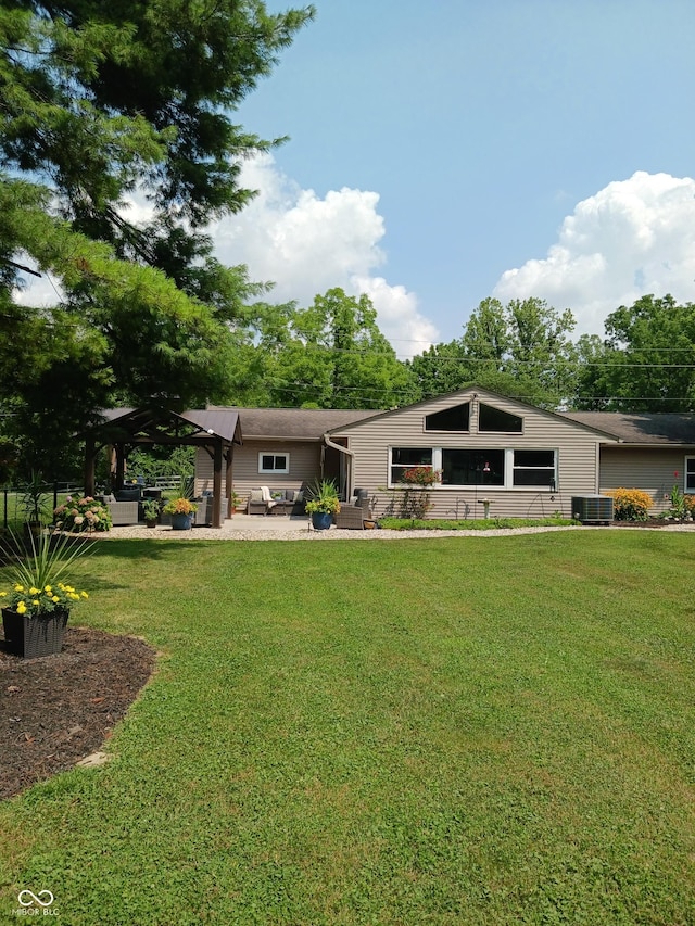 back of house with central AC, a yard, a pergola, and a patio