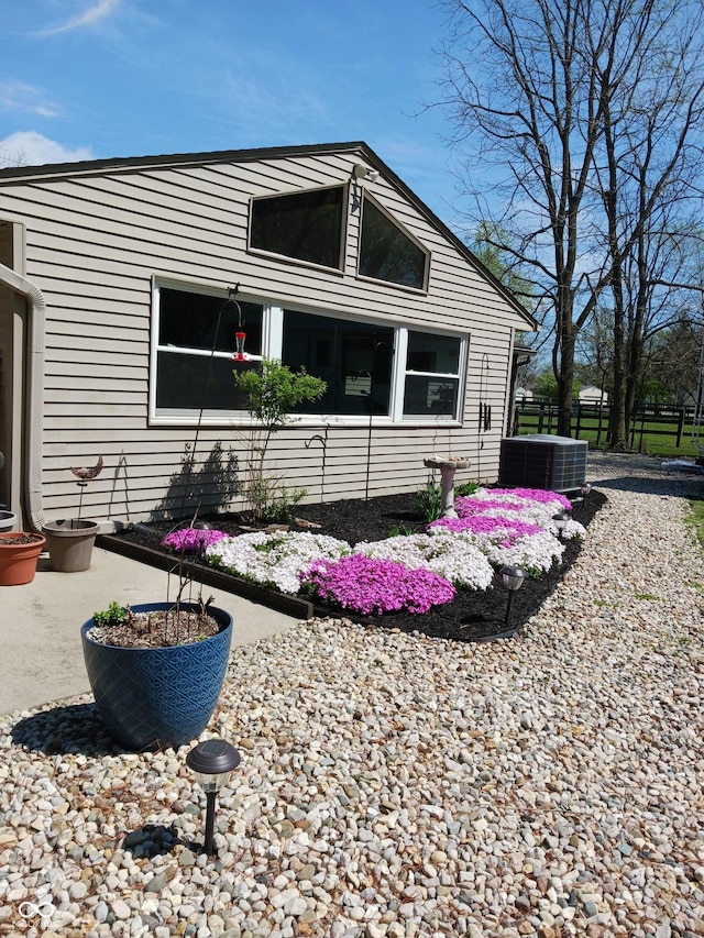 view of side of home featuring central AC unit and a patio