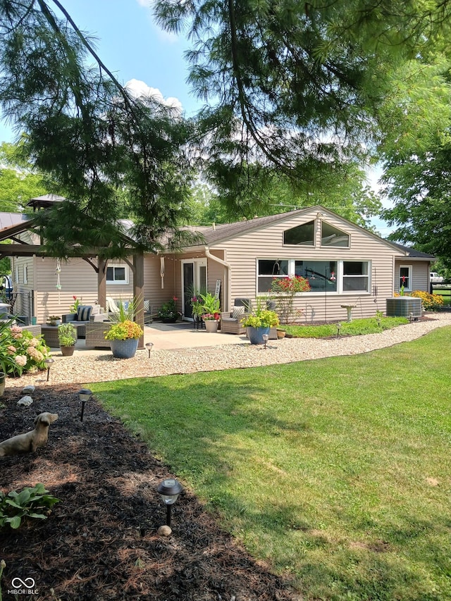 rear view of property featuring central AC unit, a patio area, and a lawn