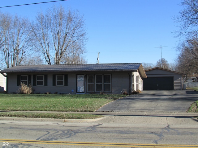 ranch-style house with a garage, an outdoor structure, and a front yard