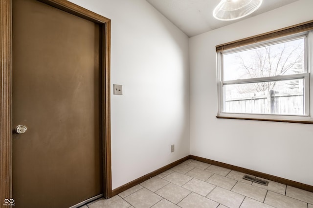 8016 Minlo Dr, Indianapolis, IN 46227 - unfurnished room featuring vaulted ceiling, healthy amount of natural light, and light tile patterned floors