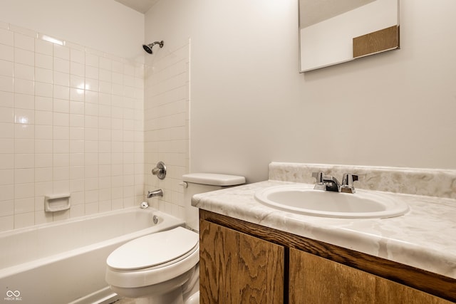 full bathroom featuring vanity, toilet, and tiled shower / bath combo