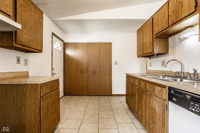 kitchen featuring lofted ceiling, white dishwasher, sink, light tile patterned floors, and range hood