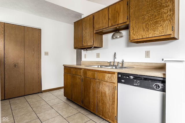 8016 Minlo Dr, Indianapolis, IN 46227 - kitchen with white dishwasher, light countertops, light tile patterned floors, and brown cabinetry
