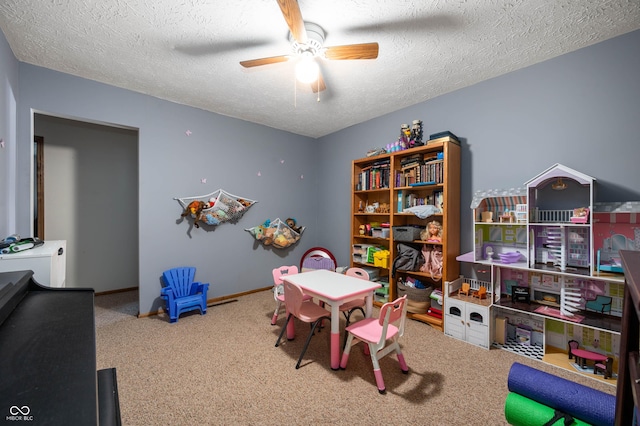 game room featuring ceiling fan, carpet floors, and a textured ceiling