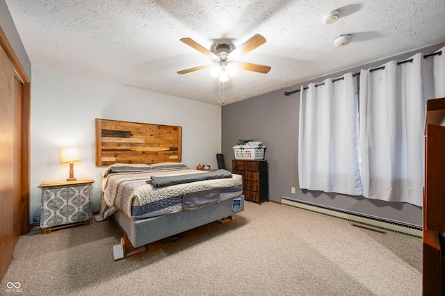 carpeted bedroom featuring a baseboard heating unit, a closet, a textured ceiling, and ceiling fan